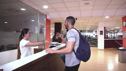 athlete talking at the information desk of a gymnasium