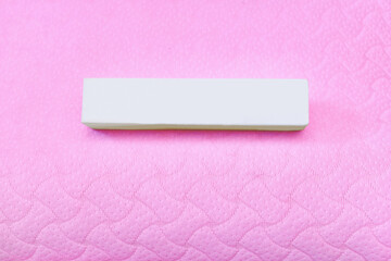 White oblong box on a pink gentle fabric textile background pillow