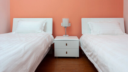 Two beds bedroom with bedside table and lamp