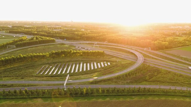 Solar panels in the middle of a highway intersection in Almere, Flevoland, The Netherlands. Sustainable green road infrastructure. Aerial hyperlapse.