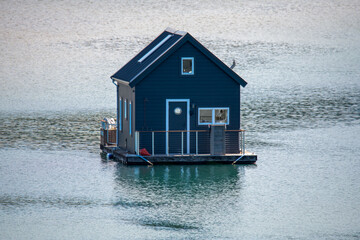 A dark blue houseboat on the Pittwater