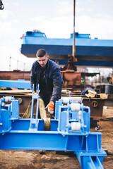 Fototapeta na wymiar Manual worker working at shipyard construction site