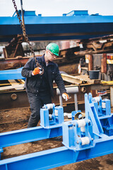 Naklejka na ściany i meble Manual worker working at shipyard construction site