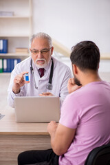 Young male patient visiting old male doctor