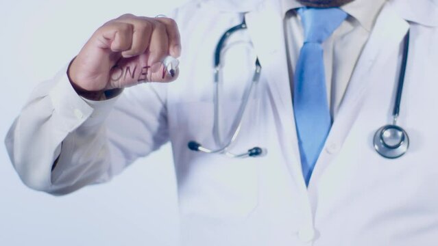 A medical doctor writes on the transparent glass words One meal a day