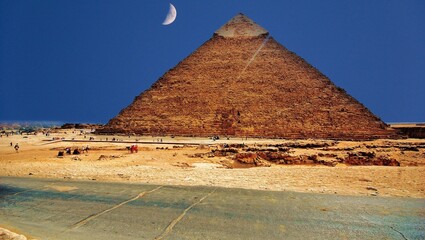 pyramids of giza with moon on blue sky 