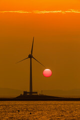 Sunset and wind in the sea with orange sky at sunset