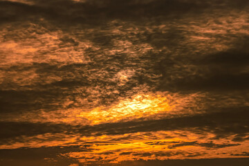 Sunset sky with clouds and rays of light. Natural background.