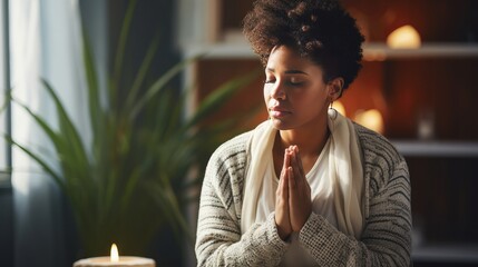 Black woman praying or meditating - obrazy, fototapety, plakaty