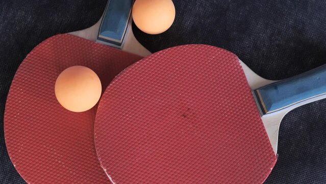 ping pong rackets and orange balls
