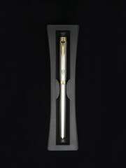 top view of a limited edition silver color business pen made of stainless steel isolated in a black background