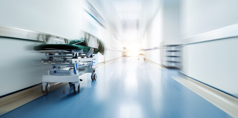 Empty hospital hallway with bed, blurred motion