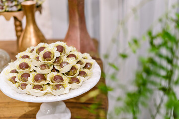 trays of chocolate brigadeiros on a table decorated with flowers for a wedding
