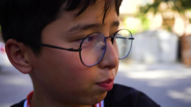  a small asian a boy with a glass beatboxing