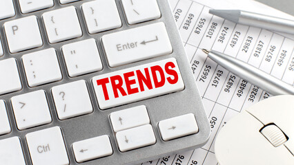 TRENDS text on a keyboard wirh chart and pencil