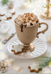 Cup of hot chocolate with marshmallow, cookies and cinnamon on festive table. Tradition Christmas winter sweet drink.