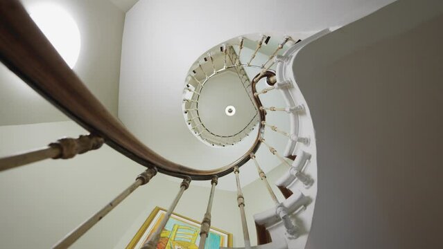 Rotating Low angle shot of spiral staircase in old vintage historical building