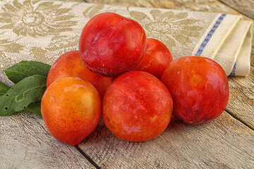 Red juicy raw plum heap