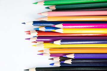 Wallpaper. Colored pencils on a white background. Set of pencils for illustrations, art, study. Concept: back to school. Rainbow, variety, mockup, copy space