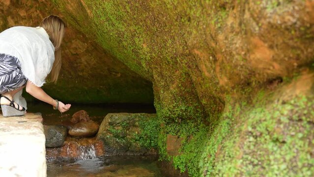 Unrecognizable Girl Water Sip: Woman Inside Gutman's Cave, Gauja National Park