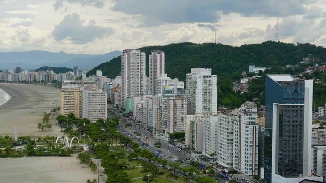 Aerial view of condos on the coastline of Santos city, partly sunny day in Brazil