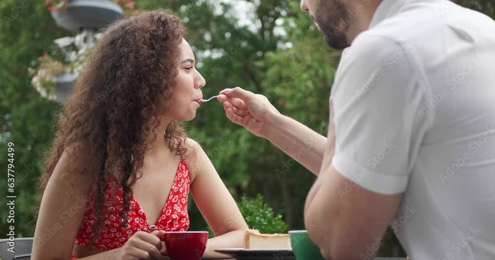 Poster Happy couple spending time together at outdoor cafe. Man feeding his girlfriend with tasty cheesecake, love angle view