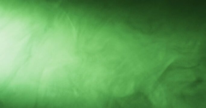 Video of green clouds of smoke moving with copy space on black background