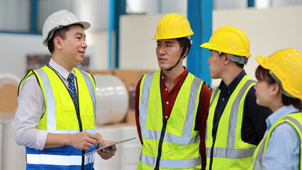 Group of asian technician engineer and businessman in protective uniform standing and discussing,...