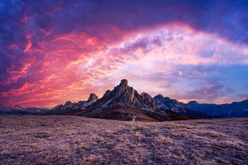 Picturesque landscape during incredible pink sunset in Italian Dolomites mountains. Passo Giau (Giau pass) with famous Ra Gusela and Nuvolau peaks on background. Dolomite Alps, Italy - obrazy, fototapety, plakaty