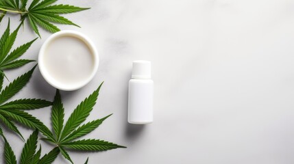 On a grey table there is a plate with green cannabis sativa leaves Cosmetic bottles without labels and a pipette are placed nearby The arrangement allows for cus. Mockup image
