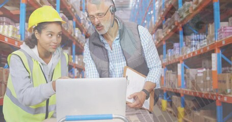 Animation of infographic interface over diverse coworkers using laptop in warehouse - Powered by Adobe