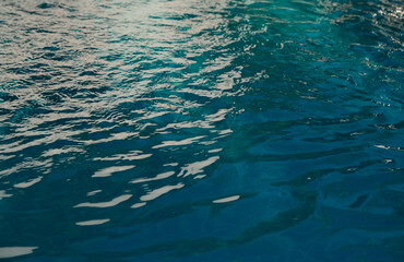 Surface of blue swimming pool. Summer background. Texture of water surface