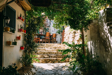 A narrow stone hillside alley with shops and homes in the ancient village of Sirince, Turkey