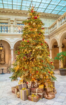 Elegant Christmas tree with gifts in a beautiful hall