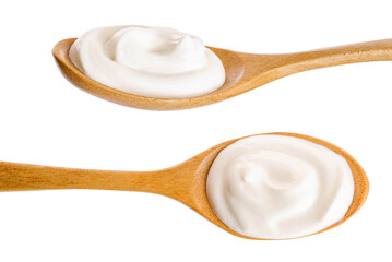 Sour cream in wooden spoon isolated on white background. Top view. Flat lay - obrazy, fototapety, plakaty
