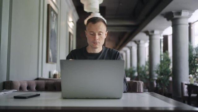 Frontal Portrait Of Businessman Working Online With Laptop In Cafe In Daytime, Person With Gadget