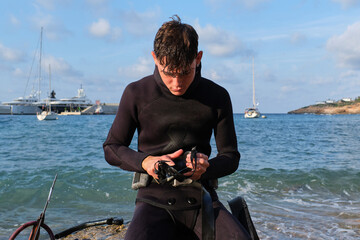 Serious man preparing for diving in sea