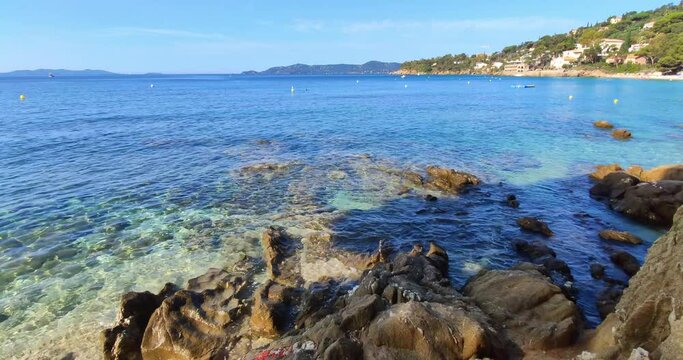 View of rocky shore at the end of Aiguebelle beach, sunny day, Le Lavandou, France