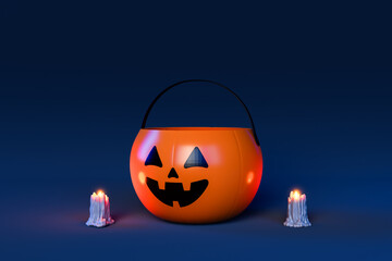 Halloween pumpkin basket with candles on blue background