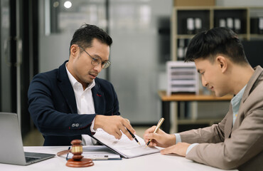 Business people and lawyers discussing contract papers sitting in the table at office in the morning. concepts of law, advice, legal services.