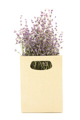 Bouquet of lavender flowers in a cardboard organic bag isolated on a white background.