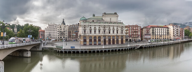 Naklejka premium Panoramic exterior view at the Arriaga square, an iconic plaza on Casco Viejo, Arriaga Theatre, bridge and Nervión river Bilbao downtown city, Spain