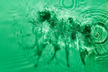 Water green surface abstract background. Waves and ripples texture of cosmetic aqua moisturizer with bubbles.