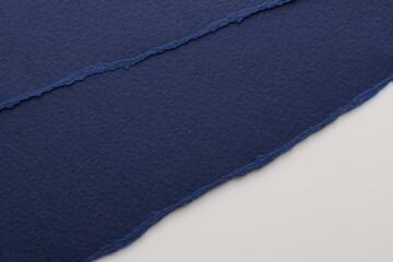 Art collage of pieces of ripped paper with torn edges. Sticky notes collection blue white colors, shreds of notebook pages. Abstract background.