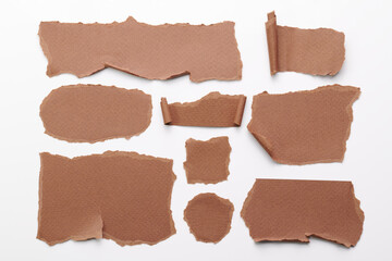 Art collage of pieces of ripped paper with torn edges. Sticky notes collection brown colors, shreds of notebook pages. Abstract background.