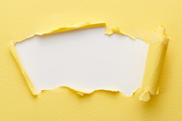 Frame of ripped paper with torn edges. Window for text with copy space yellow white colors, shreds of notebook pages. Abstract background.