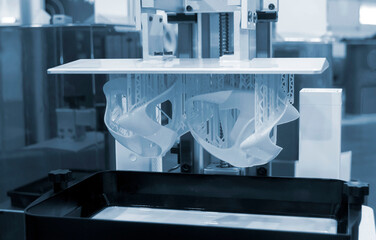 Printed models on 3D printer close-up. Objects printed on photopolymer sla 3D printer from liquid...