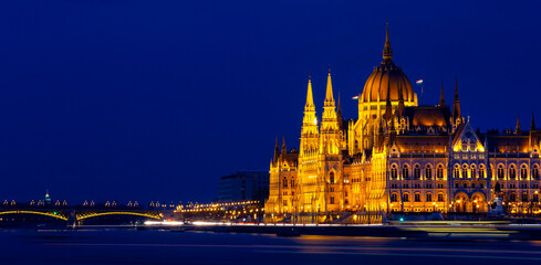 Panorama view in the night scene with building of Hungarian parliament at Danube river in Budapest city, Hungary.