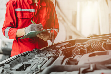 mechanic team check list engine repair maintenance oil liquid change at front hood of old car in...