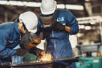 welding worker team working arc weld metal joint production in heavy industry danger and risk...